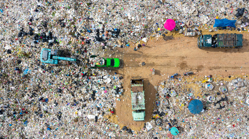Garbage pile in trash dump or open landfill, Trash trucks dump waste products polluting in an trash dump, Surface and subsurface water contamination. Aerial top view