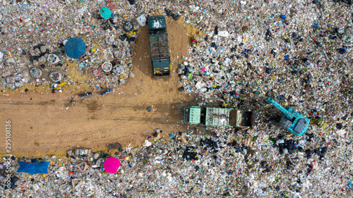 Garbage pile in trash dump or open landfill, Trash trucks dump waste products polluting in an trash dump, Surface and subsurface water contamination. Aerial top view
