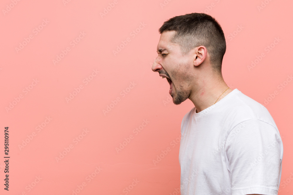 Young casual man shouting towards a copy space Young casual man shouting towards a copy space