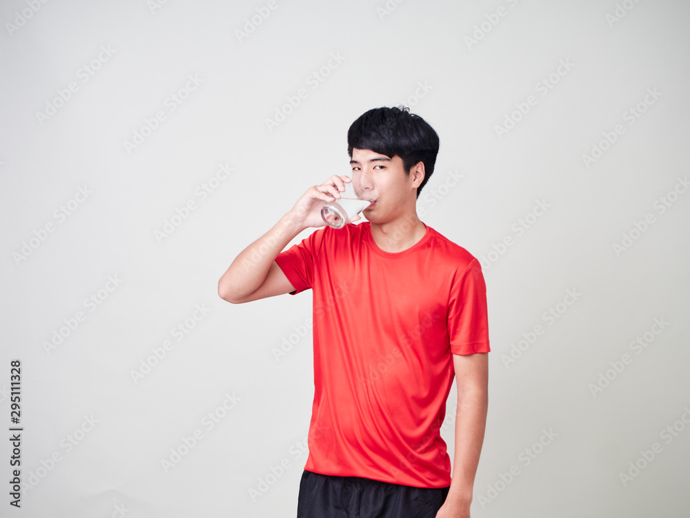 Young man drinking water of glass. Young man drinking water of glass.
