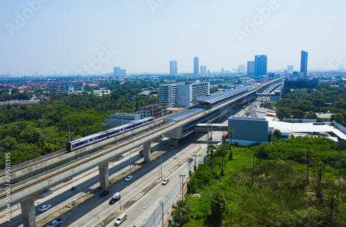 Rail track and conductor rail transportation, Aerial top view, Road Expressway traffic highway roundabout transportation with moving cars and railway tracks on which the train rides