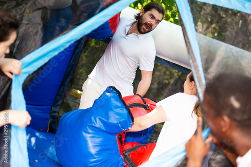 Expressive bearded guy boxing on inflatable ring
