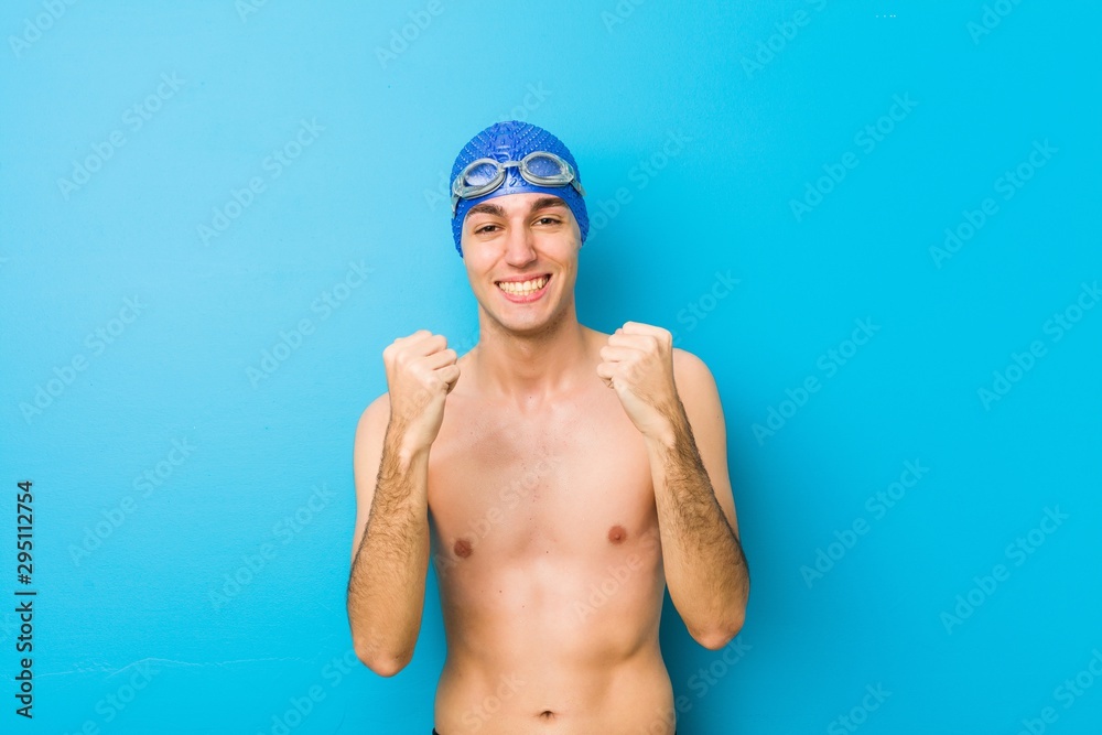 Young swimmer man cheering carefree and excited. Victory concept.