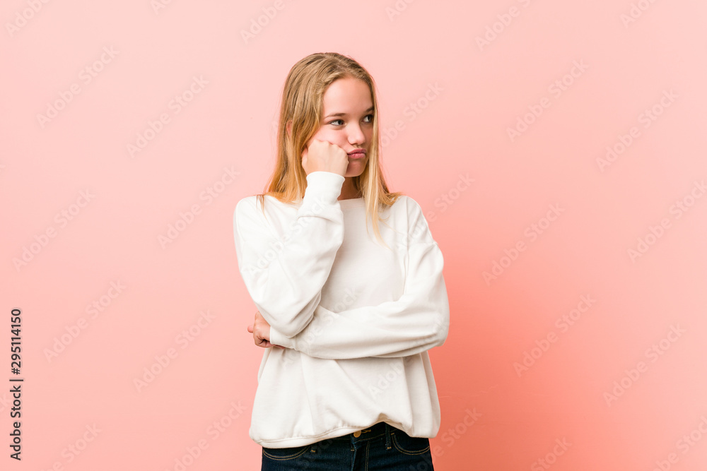 Young blonde teenager woman who feels sad and pensive, looking at copy space. Young blonde teenager woman who feels sad and pensive, looking at copy space.