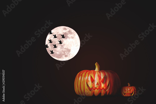 Halloween pumpkins at night under the full moon.