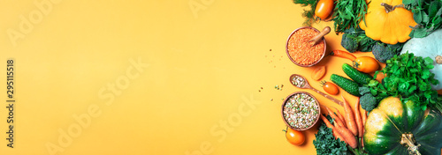 Organic vegetables, lentils, beans, raw ingredients for cooking on trendy yellow background. Healthy, clean eating concept. Vegan or gluten free diet. Copy space. Top view. Food frame