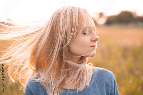 Young woman with streaming blonde hair outdoors. Close up © Dima Aslanian