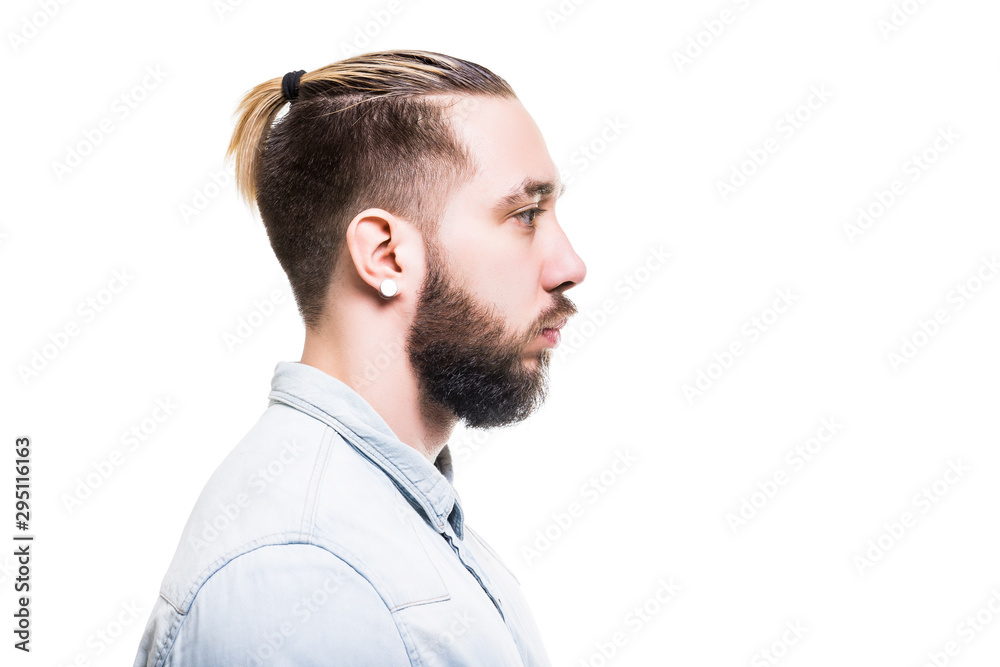 Obraz premium Closeup profile portrait of bearded caucasian man wearing shirt with serious look isolated at white background.