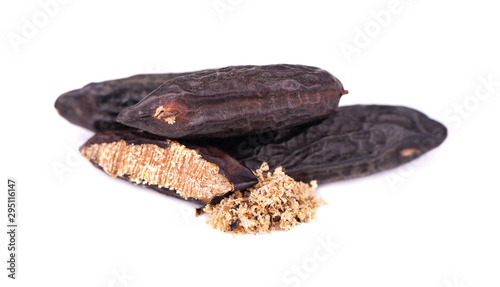 Tonka beans isolated on white background. Bean of Dipteryx odorata, cumaru or kumaru. Fresh aroma tonka bean powder. Close-up. photo