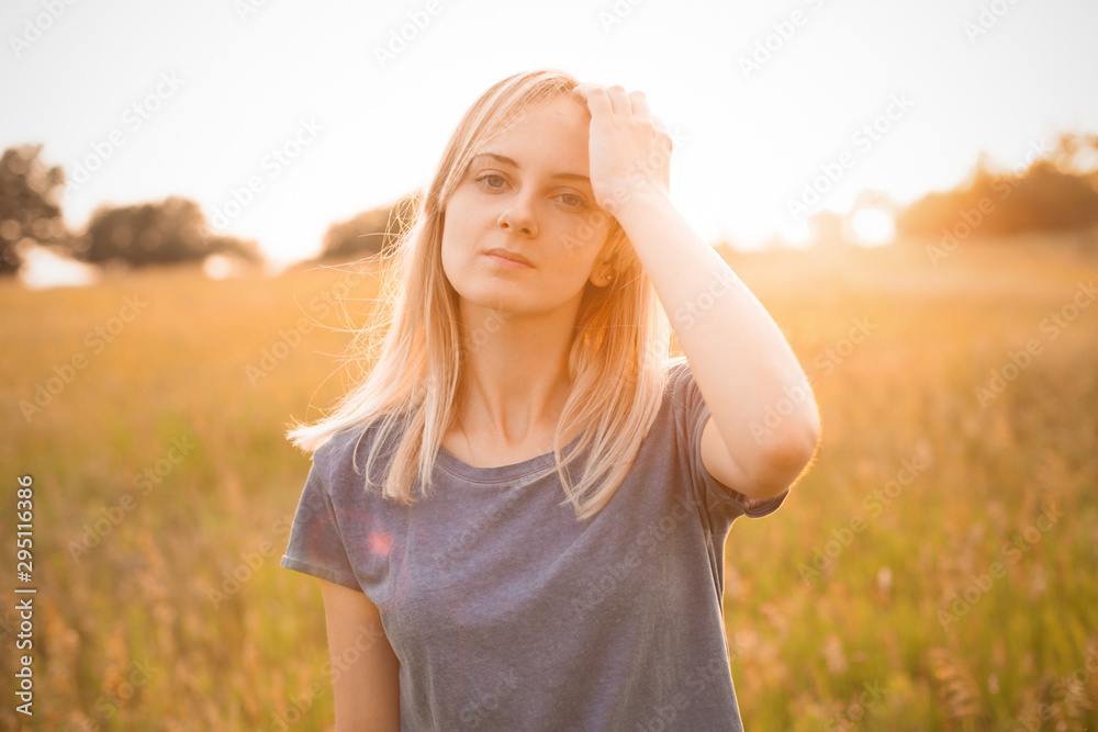 Young woman posing outdoors at sunset. Young woman posing outdoors at sunset.