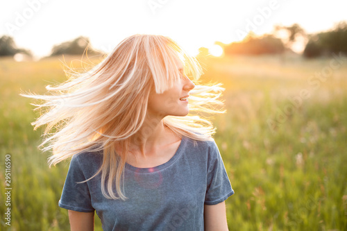 Portrait of young woman with beautiful blond hair outdoors.
