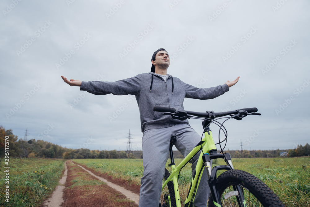 A man on a bicycle in the autumn on a field road A man on a bicycle in the autumn on a field road