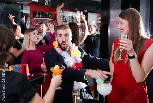 Man with girlfriend on Hawaiian party in bar