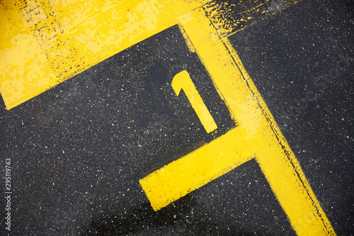 Obraz na plátně Number one sign on the road, motor race sign on the asphalt, the best pole posit