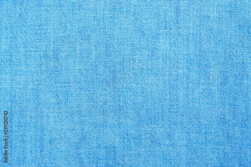 Closeup of cotton mixed with polyester fabric in light blue and turquoise tone for textile texture and bright glossy cool banner background