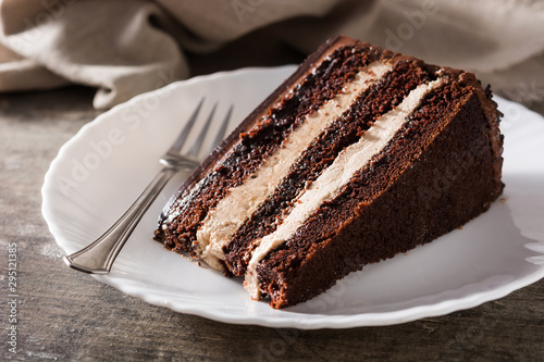 Fototapete Chocolate cake slice on wooden table