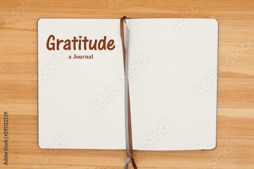 Картината върху платно Gratitude journal on a wood desk