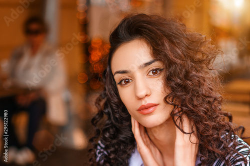 portrait of a beautiful young woman with curly hair closeup © Екатерина Переславце