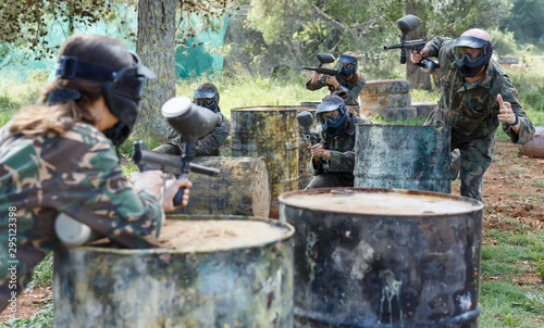 gambling teams facing on battlefield in outdoor paintball arena