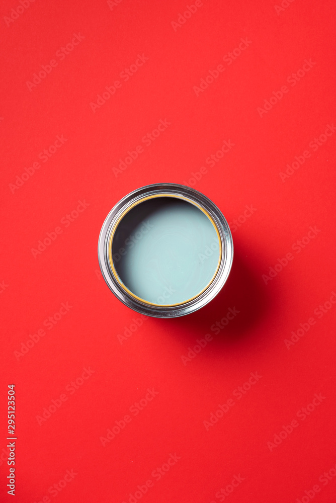 Open paint can on trendy red background. Top view, copy space. Appartment renovation, repair, building and home design concept. Open paint can on trendy red background. Top view, copy space. Appartment renovation, repair, building and home design concept.