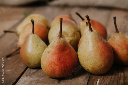 Several ripe pears lie on boards
