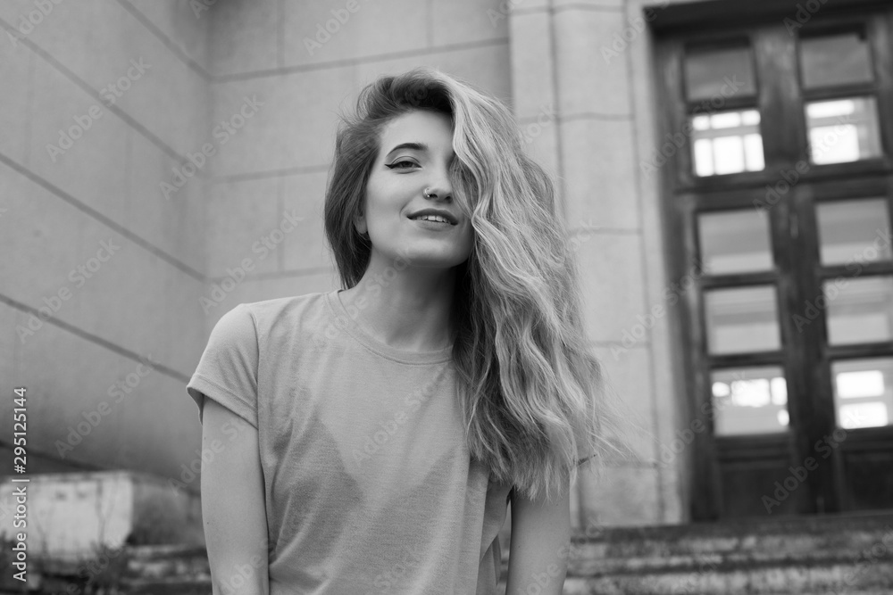 Young fashionable woman walking in the city. Black and white Young fashionable woman walking in the city. Black and white
