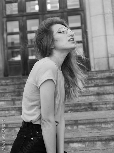 Young fashionable woman walking in the city. Black and white