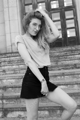 Young fashionable woman walking in the city. Black and white