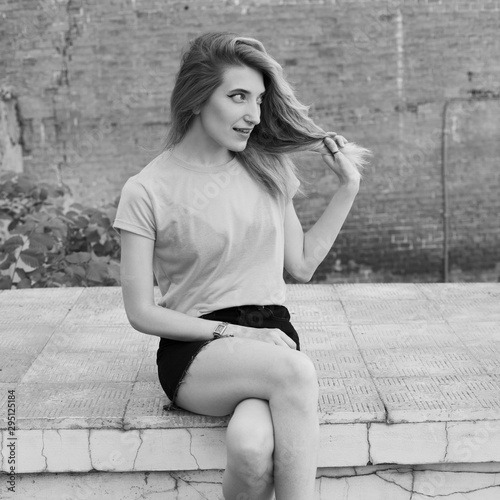 Young beautiful woman sitting in the city