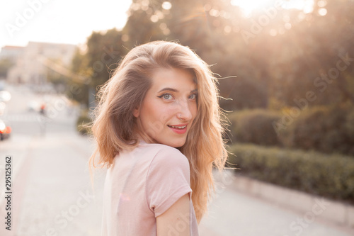 Portrait of young woman with beautiful hair outdoors.