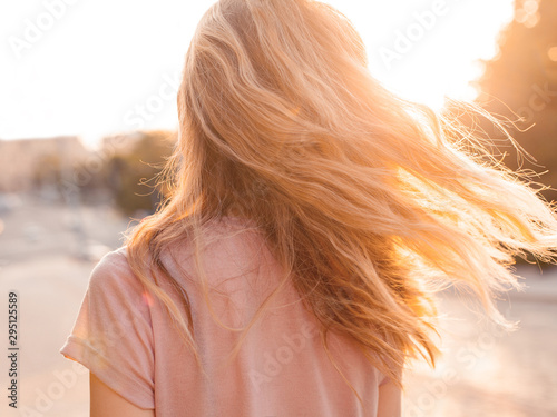 Young woman with golden hair. Back
