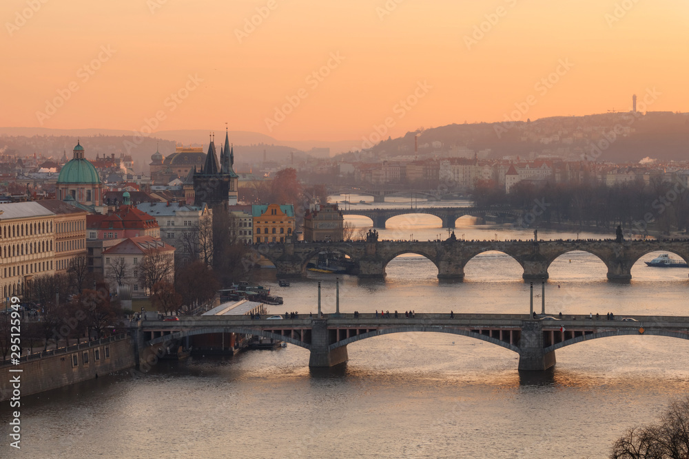 Golden sunset light over old bridges of Prague, Czechia