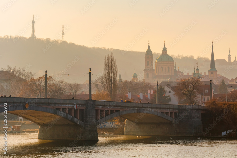 Golden sunset light over Manes bridge in Prague, Czechia