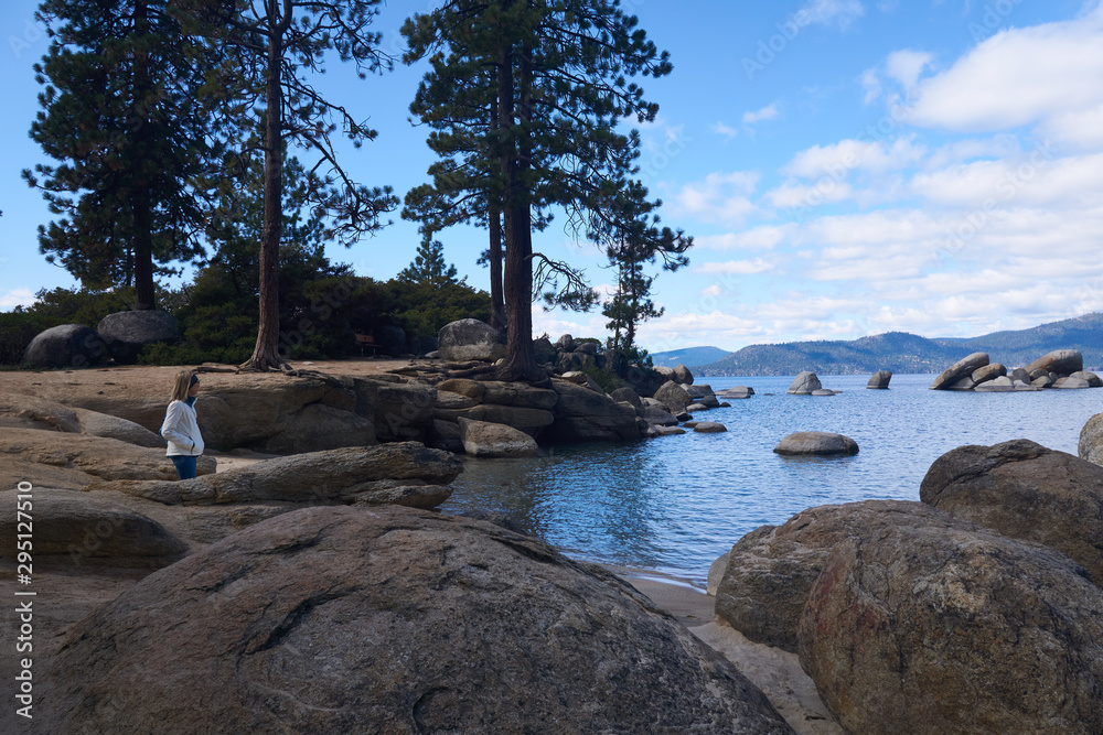 Woman tourist enjoying the view of Sand Lake Harbor State Park Woman tourist enjoying the view of Sand Lake Harbor State Park
