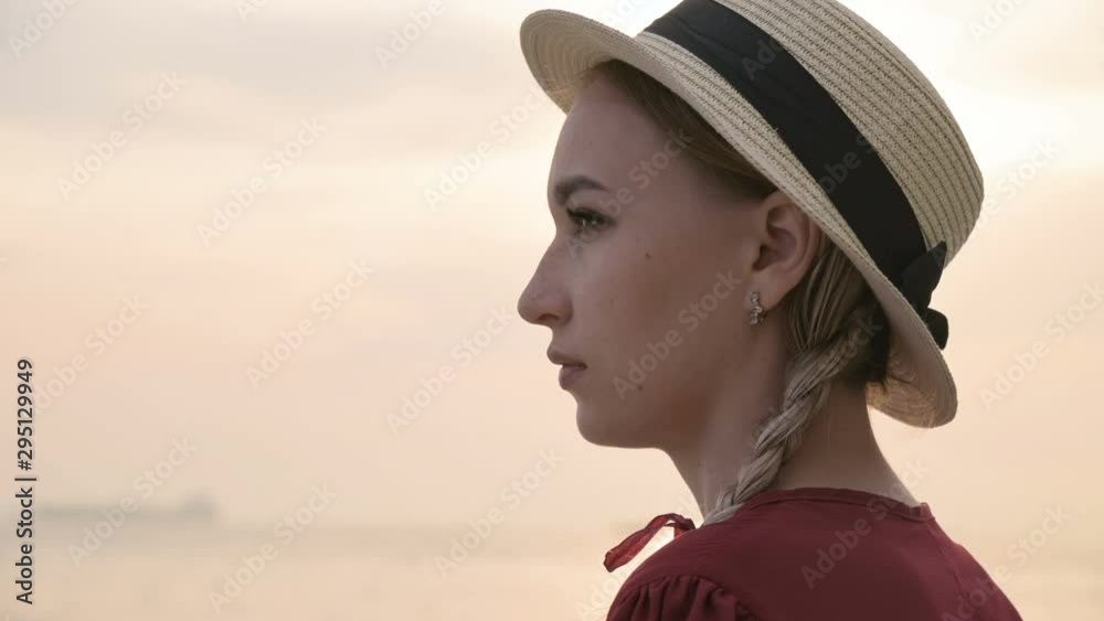 Big close-up face Portrait of an attractive caucasian young woman in a straw hat with pigtails looks away Big close-up face Portrait of an attractive caucasian young woman in a straw hat with pigtails looks away