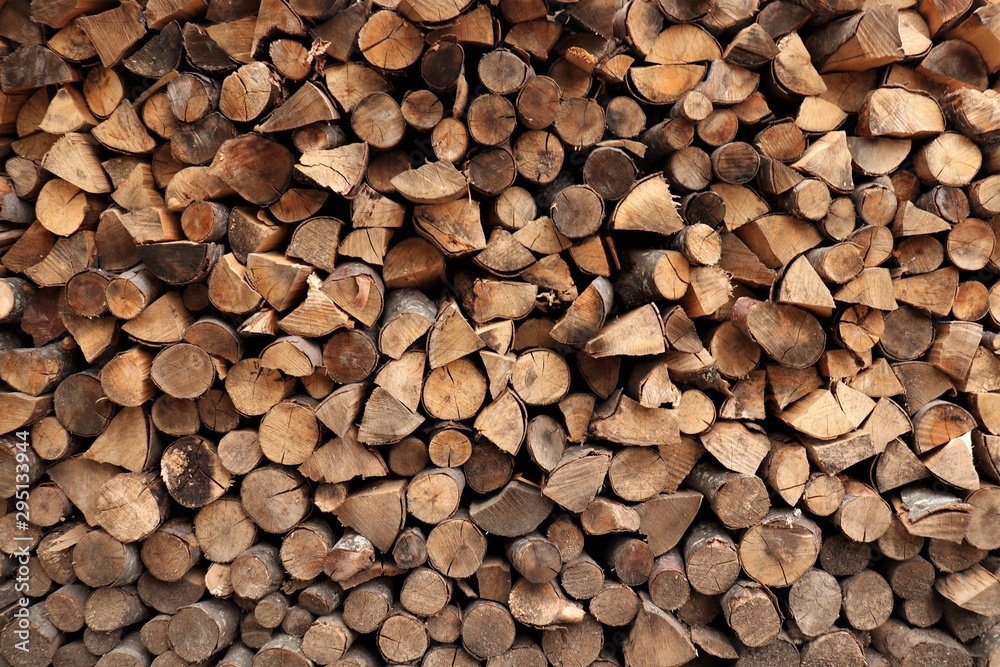 round and triangular firewood neatly stacked round and triangular firewood neatly stacked
