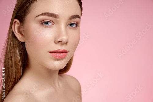 Adorable girl with perfect soft skin looking at camera