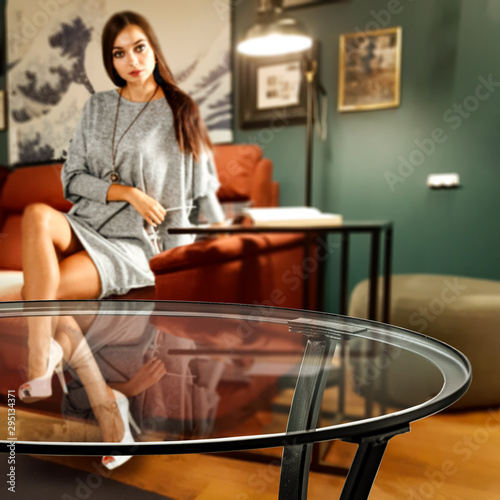 Slim young woman and home interior with coffee table. 