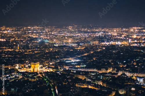 Aerial view of the Arc de Triomphe de l'Etoile (The Triumphal Arch) in Paris at night with traffic lights