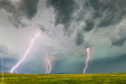 Multiple bolts of lightning strike the ground during a lightning storm.