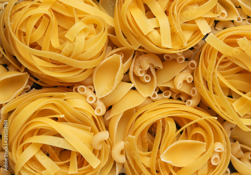 Background of diifferent types of raw italian pasta. photo