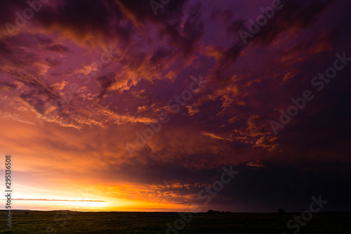 Dramatic orange and purple colours as the sun sets after a large storm