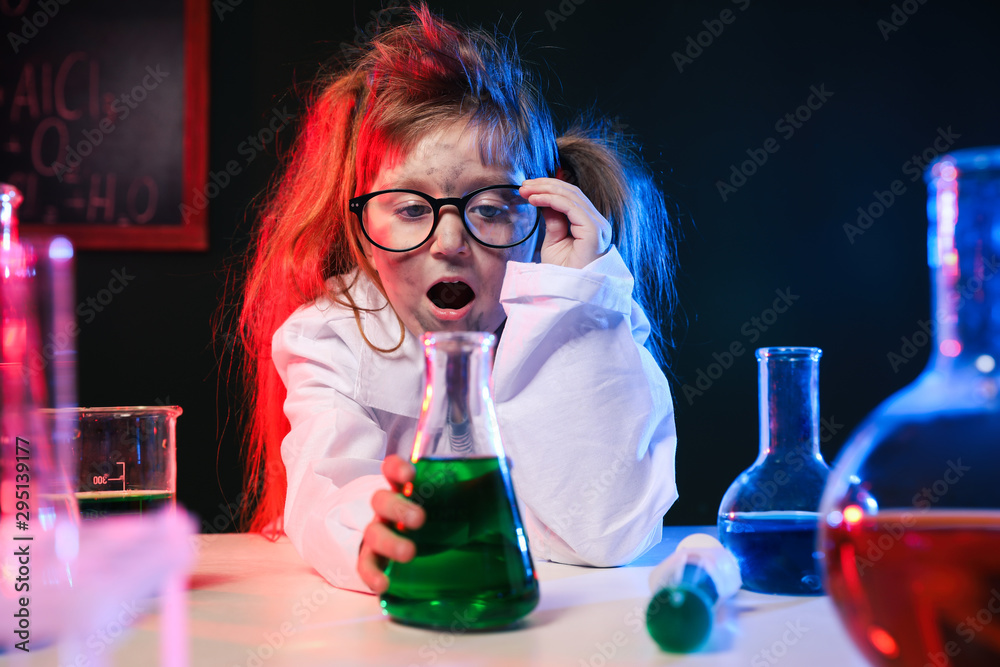 Child doing chemical research in laboratory. Dangerous experiment Child doing chemical research in laboratory. Dangerous experiment