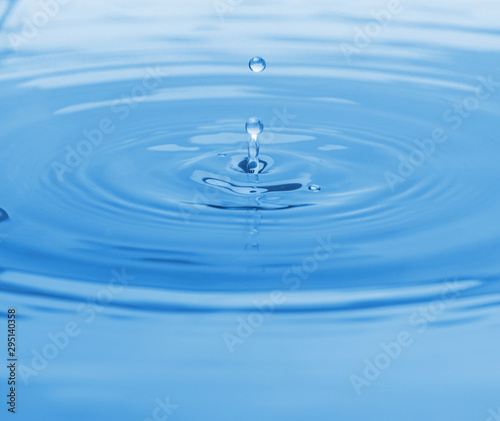 Splash of blue water with drop, closeup
