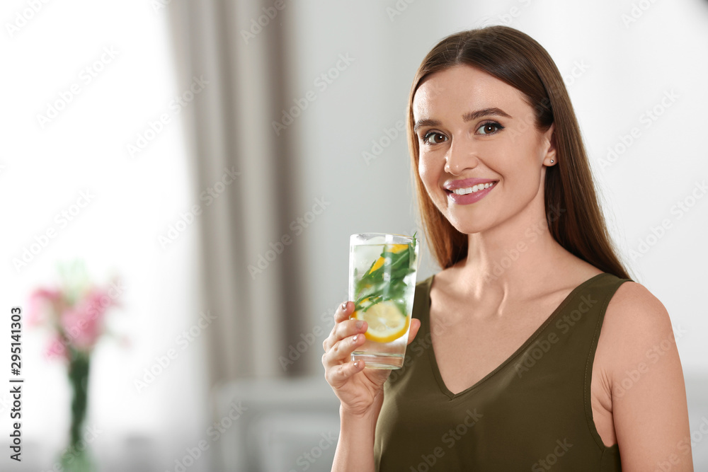 Young woman with lemonade at home. Refreshing drink Young woman with lemonade at home. Refreshing drink