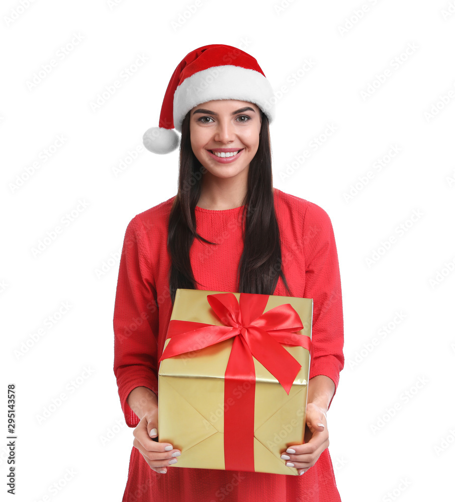 Happy young woman in Santa hat holding Christmas gift on white background Happy young woman in Santa hat holding Christmas gift on white background