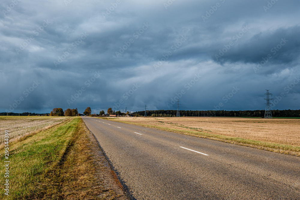 storm clouds over asphalt road in perspective storm clouds over asphalt road in perspective