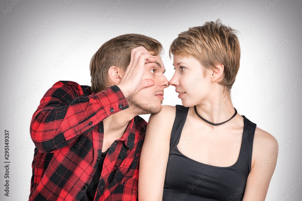 Man and woman sitting close together looking at each other