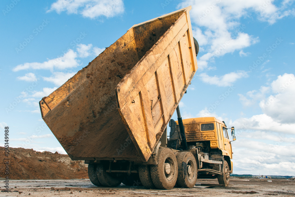 Fototapeta premium Old dump truck at a construction site. Equipment for construction.