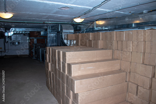 Cardboard boxes with goods in the basement. photo